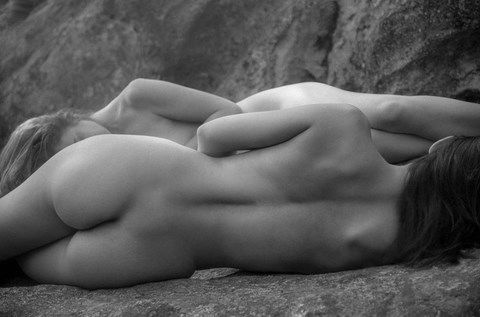2 femmes nues couchées sur un rocher
